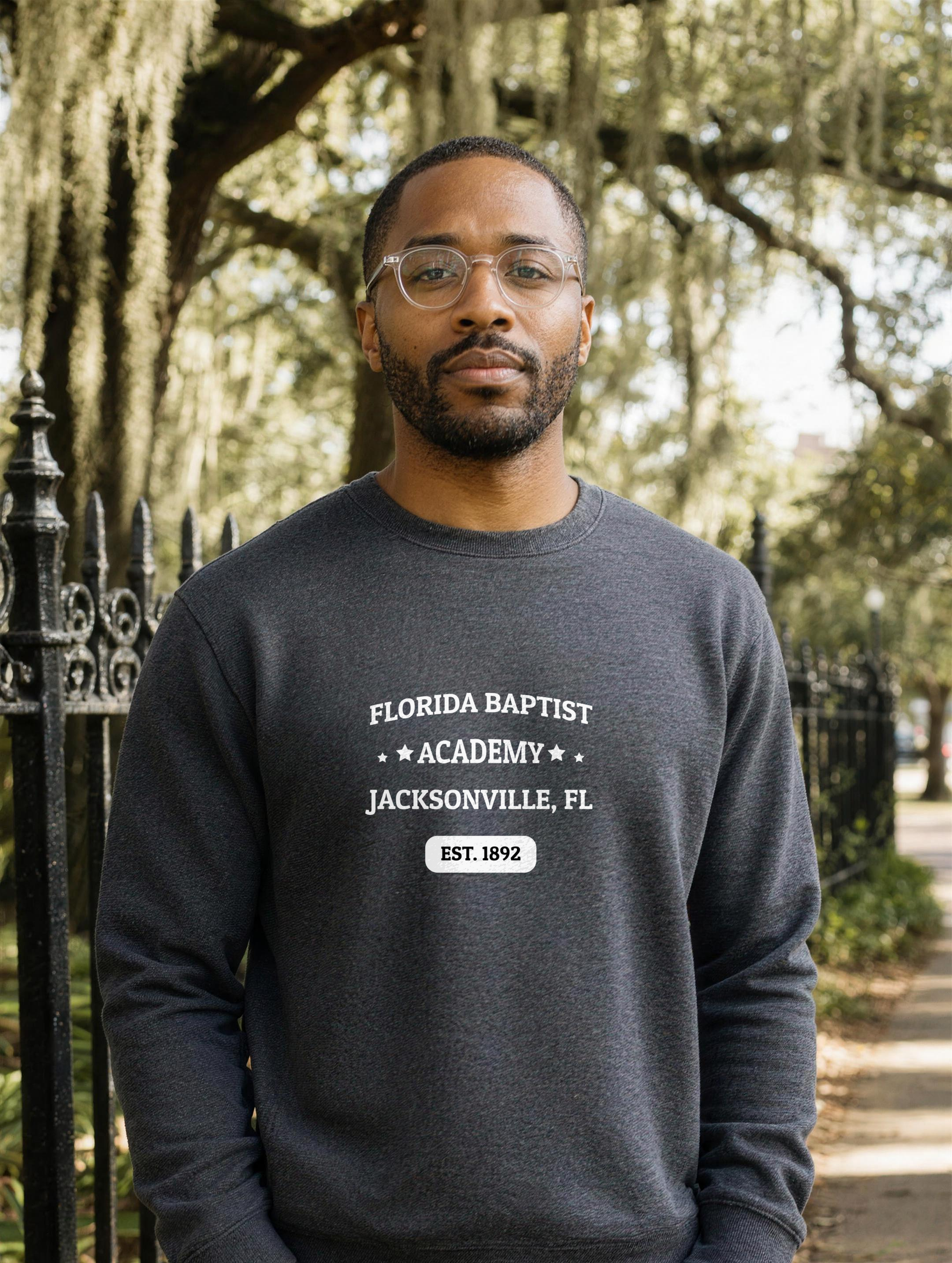 Premium Sweatshirt in Charcoal Heather with the Florida Baptist Academy 1892 heritage lockup — worn