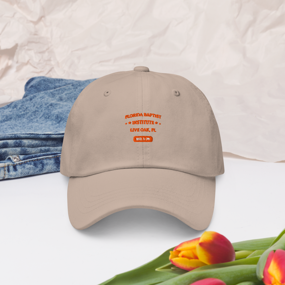 Florida Baptist Institute Heritage Dad Hat, front view on stone
