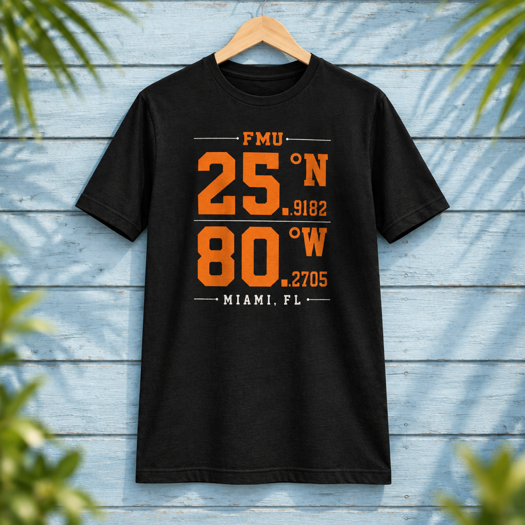 Florida Memorial University Coordinates Black t-shirt with orange and white campus-coordinate artwork, displayed front-facing on a hanger against pale-blue clapboard; creative mockup.