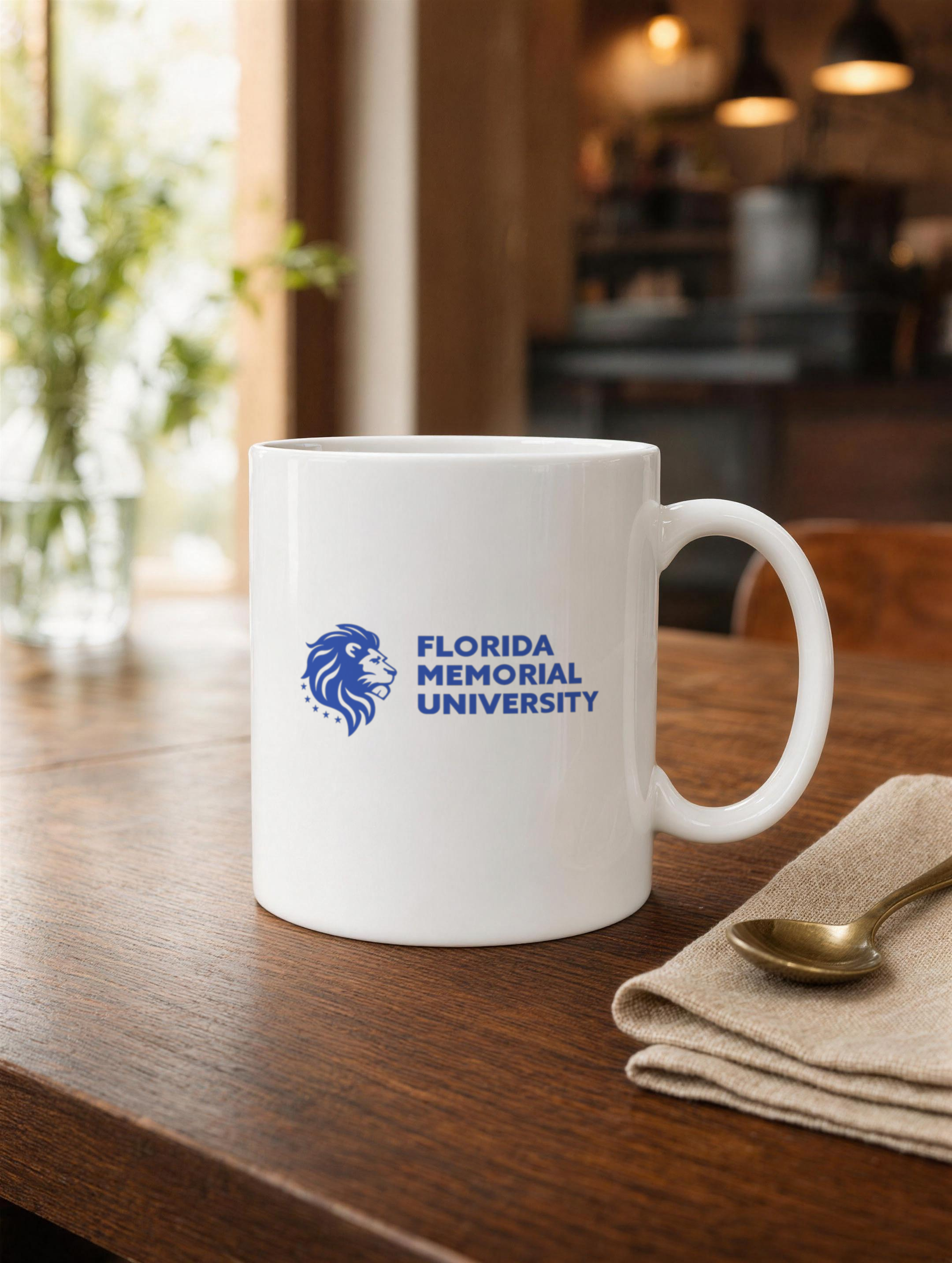 Florida Memorial University Stacked Wordmark white glossy mug on a walnut cafe table with a linen napkin and brass spoon