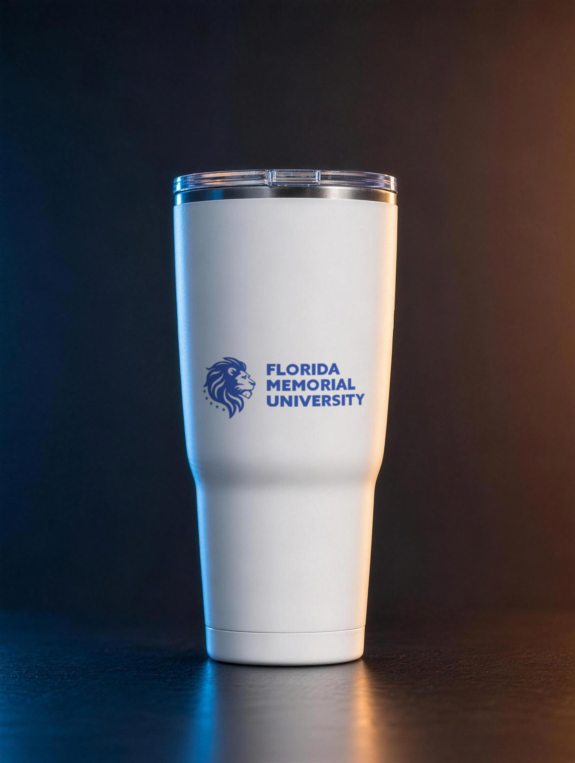 Florida Memorial University Stacked Wordmark stainless steel tumbler under royal blue and amber split gel lighting
